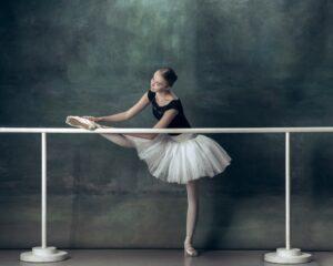 The classic ballerina posing at ballet barre